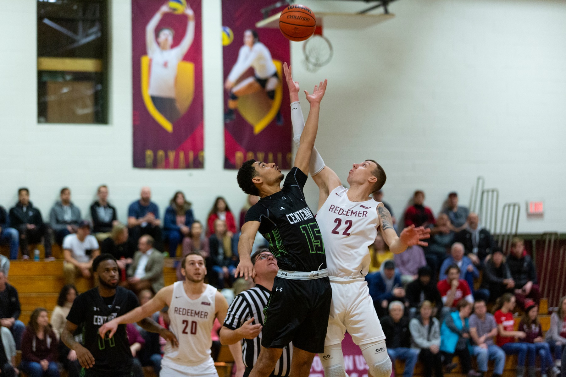 Centennial's Kyrin Henlin and Redeemer's Spencer Kerssies jump up for tipoff during Saturday afternoon's playoff crossover game between the two teams. (John Theurer/Colts Media)