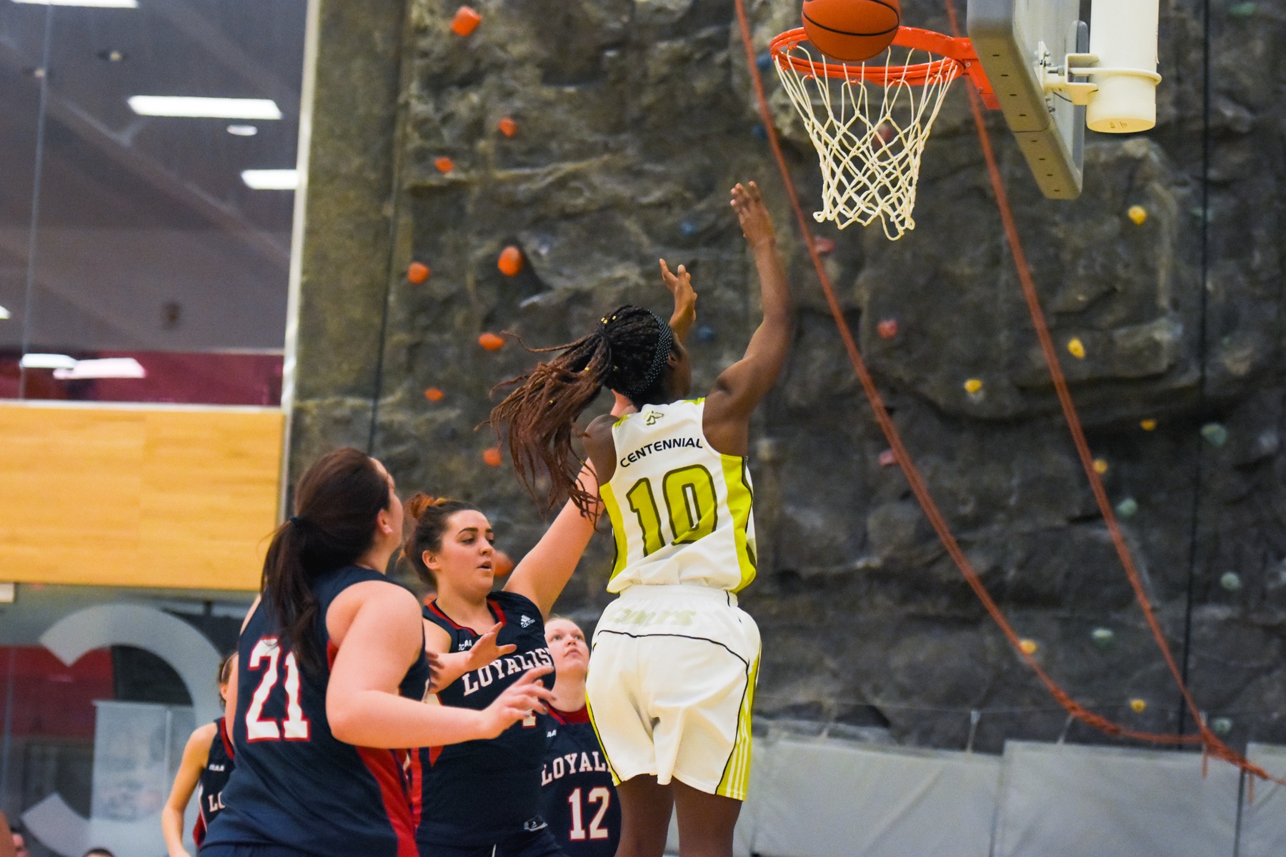 The Colts' Yasmeen Smith attempts a layup with three Loyalist defenders looking on. Smith's layup with 5.9 seconds left gave Centennial a 54-52 win over the Loyalist Lancers, at Athletic and Wellness Centre.